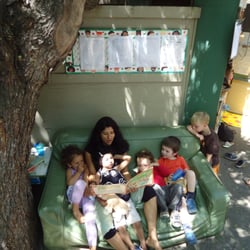 Play Mountain Place - A book is read by a teacher to children in Little Nursery.