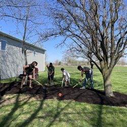 John Lasley Outdoor Solutions - Crew mulching.