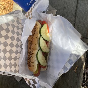Dogs-a-Foot - ows a hot dog with cucumbers and tomatoes - Food Stands Near Me - Port Townsend, Washington
