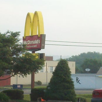 McDonald's - a red car driving past a mcdonald's sign - Burgers Near Me - Elysburg, Pennsylvania