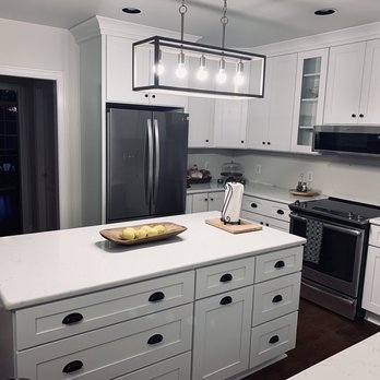 EuroStone - a kitchen with white cabinets and a center island - Countertop Installation Near Me - Murfreesboro, Tennessee
