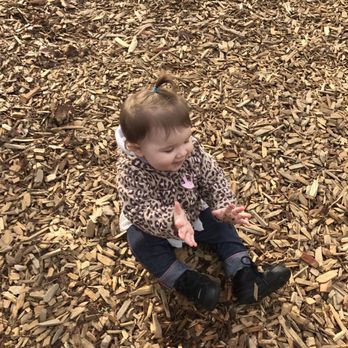 Learning Land Early Learning Program -Kent Campus - Playing on the playground. She loves the bark. - Child Care & Day Care Near Me - Kent, Washington