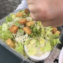 Harbor Eats - The yummy Caesar salad they replaced my taco for. Don't know why there's a hand in the photo. $7without chicken
