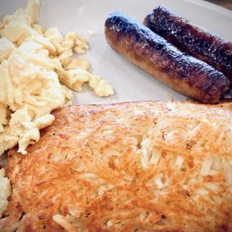 Scrambled eggs, sausage links and hash brown part of the sausage-and-egg pancake special