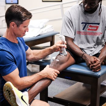 RAM Performance and Rehab - CFL Football player finishing up manual physical therapy. - Physical Therapy Near Me - Orlando, Florida RAM Performance and Rehab - CFL Football player finishing up manual physical therapy. - Physical Therapy Near Me - Orlando, Florida