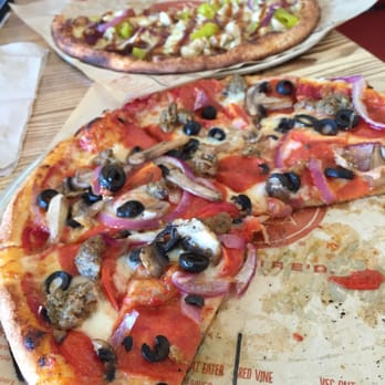 Blaze Pizza - BBQ chicken plus garlic, Meat Eater plus olives, tomatoes and mushrooms. - Salad Near Me - Austin, Texas