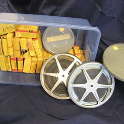 Leave A Legacy - A tub of old film reels that we transferred to DVD and digital files for a client. Family memories preserved and ready to share.