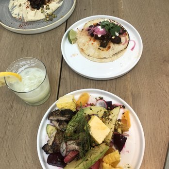 St. Kilda Collective - Roasted beet salad with chicken. Hummus and steak taco appetizers. Piña colada rum drink. - Cafes Near Me - West Des Moines, Iowa