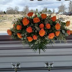 Fit For A Queen Florist - Deluxe Casket Spray with Orange Crush Roses.