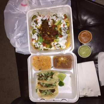 Taco Grande - Fiesta nachos with Al pastor on top. And the taco plate which comes with three tacos, rice, and beans. - Mexican Near Me - Lewisville, Texas Taco Grande - Fiesta nachos with Al pastor on top. And the taco plate which comes with three tacos, rice, and beans. - Mexican Near Me - Lewisville, Texas