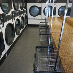 Falls Coin Wash & Laundry - Dryers and laundry baskets.