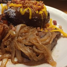 Steak and grilled chicken with loaded baked potatoes. Steak and grilled chicken with loaded baked potatoes.