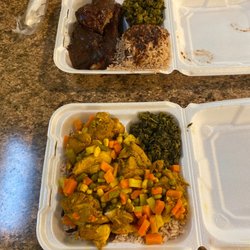 Jamaican Jerk Hut - Jerk Chicken and Chicken curry both with red beans and rice side of steamed calaloo