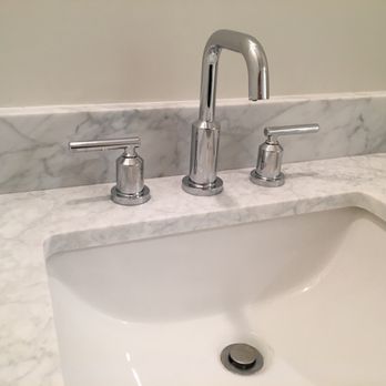 JT Custom Builders - a bathroom sink with two faucets - General Contractors Near Me JT Custom Builders - a bathroom sink with two faucets - General Contractors Near Me