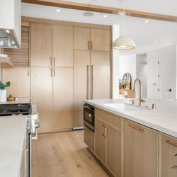 Custom kitchen -- white-oak cabinetry, quartz counters, and pro-grade appliances