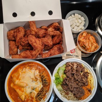 Bonchon Chapel Hill - Combo medium soy garlic w/ pickled radish ($24.65), kimchi ($3.00), tteokbokki ($10.95), and bulgogi bibimbap ($13.95). Takeout. - Korean Near Me - Chapel Hill, North Carolina