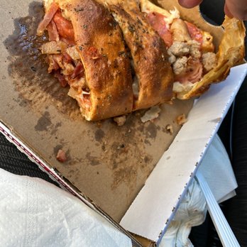 3.99 Pizza -  a half eaten sandwich - Chicken Wings Near Me - Montclair, California