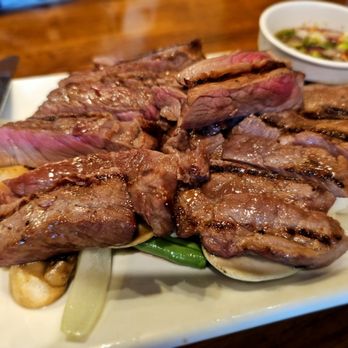 Kaohorm Kitchen - a plate of steak with onions and pickles - Thai Near Me - Sherman Oaks, California