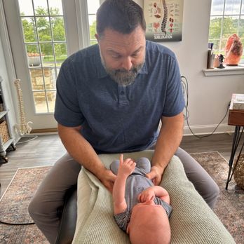 Willow Wellness and Chiropractic Care - Dr. Indy gently adjusting a 6 week old baby. - Chiropractors Near Me - Doylestown, Pennsylvania Willow Wellness and Chiropractic Care - Dr. Indy gently adjusting a 6 week old baby. - Chiropractors Near Me - Doylestown, Pennsylvania