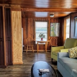 Runaway Bay Lodge - Living room and dining area with water views
