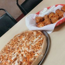a pizza and a basket of chicken nuggies a pizza and a basket of chicken nuggies