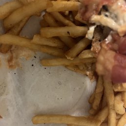 A curled hair in the food. This hair was right below the burger. A curled hair in the food. This hair was right below the burger.