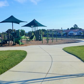 Sungold Park - Walkway to the play structures, located after the tables/benches area. Seating around the perimeter. Nice park to bike and scooter around! - Parks Near Me - Brentwood, California Sungold Park - Walkway to the play structures, located after the tables/benches area. Seating around the perimeter. Nice park to bike and scooter around! - Parks Near Me - Brentwood, California