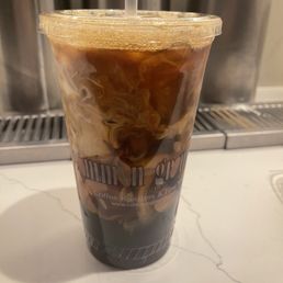Simple iced coffee w/ pistachio and vanilla flavoring. Topped w/dairy. YUM.
