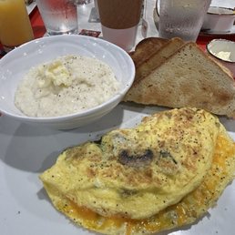 Spinach, onion, mushroom and cheddar omelette with amazing grits and homemade country white toast. Spinach, onion, mushroom and cheddar omelette with amazing grits and homemade country white toast.