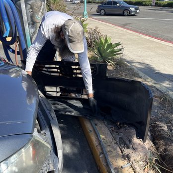 Fix Auto North Park - The car wash employee assessing the bumper. Hanging by only the left edge! - Body Shops Near Me - San Diego, California Fix Auto North Park - The car wash employee assessing the bumper. Hanging by only the left edge! - Body Shops Near Me - San Diego, California