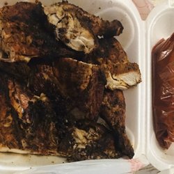Grilled whole chicken (cut) with a side of hot red chipotle salsa