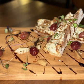 Studio Lounge - a wooden cutting board with food on it - Cocktail Bars Near Me - Rochester, New York Studio Lounge - a wooden cutting board with food on it - Cocktail Bars Near Me - Rochester, New York