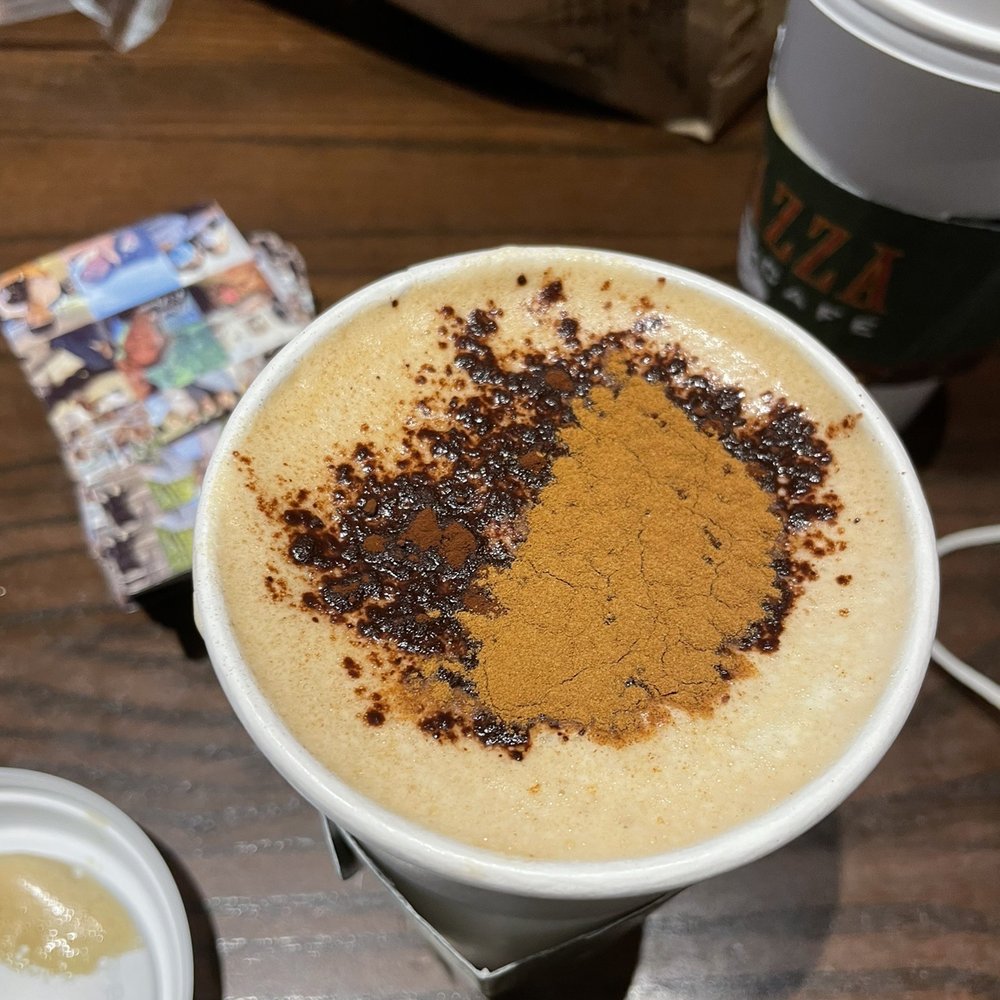 a cup of cappuccino on a table a cup of cappuccino on a table