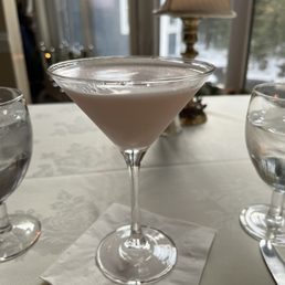 a martini in a glass on a table a martini in a glass on a table
