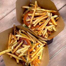 Fries piled high on top of chicken sandwiches Fries piled high on top of chicken sandwiches