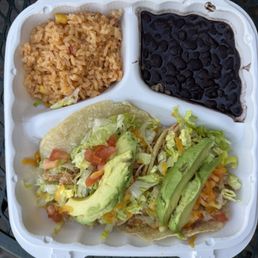 Shredded chicken tacos with avocado, Mexican rice and black beans