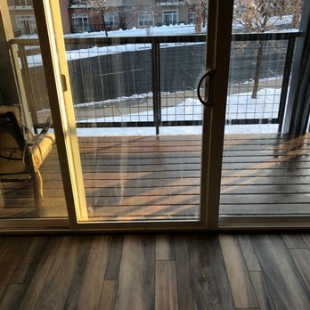 Nip & Tuck Flooring - a view of a balcony through a sliding glass door - Flooring Near Me Nip & Tuck Flooring - a view of a balcony through a sliding glass door - Flooring Near Me