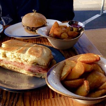 The Table - Muffuletta (bottom left), Happy Hour Burger (top left), Crispy Potato Wedges (right) | IG: @nomwithelaine - New American Near Me - San Jose, California