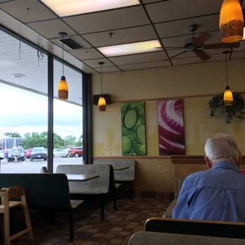 Subway - a man sitting at a table in a restaurant - Sandwiches Near Me - Ames, Iowa Subway - a man sitting at a table in a restaurant - Sandwiches Near Me - Ames, Iowa