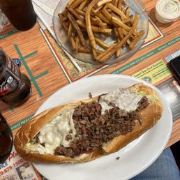 Cheesesteak sub and fries. Cheesesteak sub and fries.