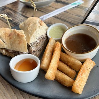 Canvas - French Dip w/ upgraded honey drizzled, twice fried yuca fries (and cilantro crema) - New American Near Me - Orlando, Florida Canvas - French Dip w/ upgraded honey drizzled, twice fried yuca fries (and cilantro crema) - New American Near Me - Orlando, Florida