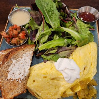 First Watch - Ordered chorizo chilli omelet with greens (salad). Sides: pico de gallo for omelet, Italian dressing for salad, raspberry jam for toast. - Breakfast & Brunch Near Me - San Antonio, Texas