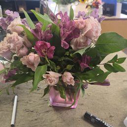 A flower bouquet in a pink vase.