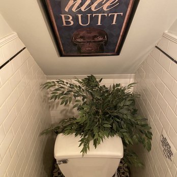 The Hog - a toilet in a bathroom with a picture above it - Sandwiches Near Me - Wappingers Falls, New York The Hog - a toilet in a bathroom with a picture above it - Sandwiches Near Me - Wappingers Falls, New York