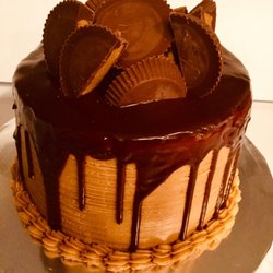 600 Sweets & Treats - Moist chocolate cake covered with flavorful peanut butter frosting, a rich milk chocolate ganache, and topped with peanut butter cups.