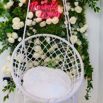 Nas Cafe - a hanging chair with flowers and greenery - Cafes Near Me - Philadelphia, Pennsylvania