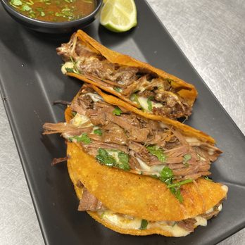Bay Area Mexicana - 3 quesabirrias  served with beef birria consommé on the side - Food Trucks Near Me - Bloomington, Illinois