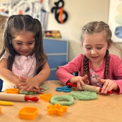Sunshine House - Building fine motor strength and hand eye coordination! Creative playdough time encourages social interaction and imaginative play.