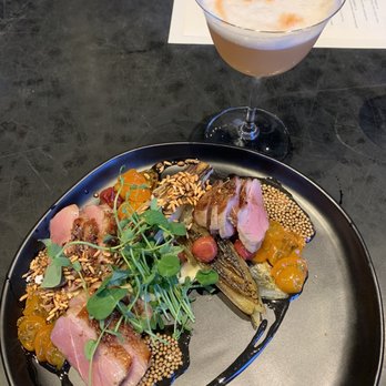 Inland Pacific Kitchen - Duck breast entree and Rye's and Shine cocktail - Cocktail Bars Near Me - Spokane, Washington