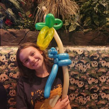 Rainforest Cafe - A balloon monkey climbing a palm tree - American Near Me - Gurnee, Illinois Rainforest Cafe - A balloon monkey climbing a palm tree - American Near Me - Gurnee, Illinois